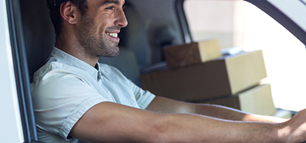 happy man in car with boxes